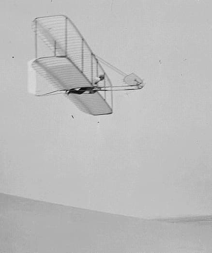 A Wright glider soaring over the dunes at Kitty Hawk, 1902